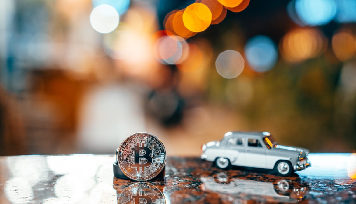 silver bitcoin and moskvich 401 on the table, glowing background